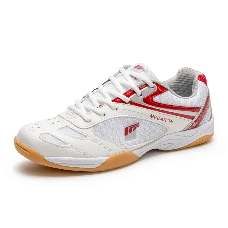 White table tennis sneakers with red trim, showing round toe and lace-up front.