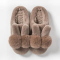 Women's fluffy rabbit fur slippers in pink, shown as slip-on winter shoes.