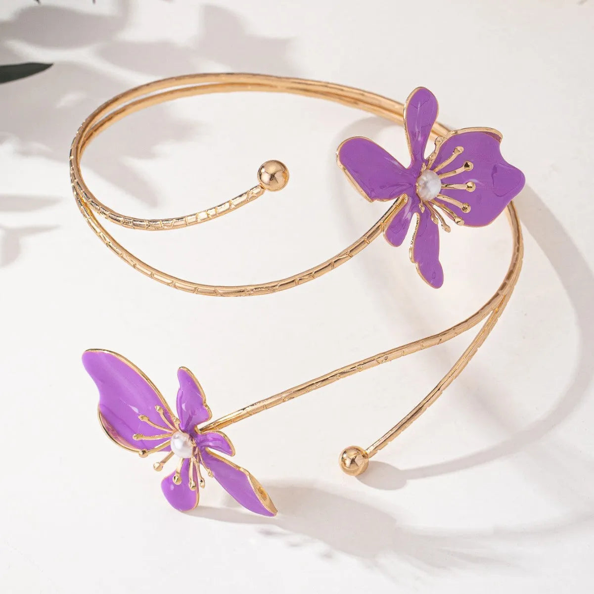 Pink hollow-out pattern alloy armband with adjustable lines on a wrist.