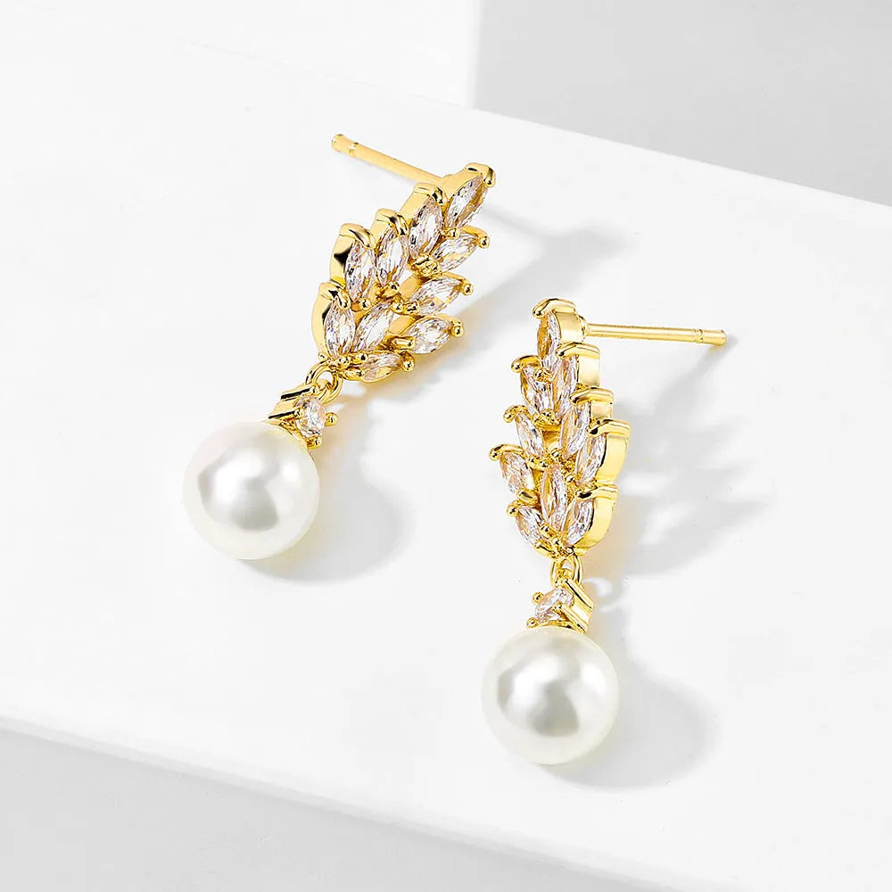 Geometric earrings with white floral micro inlay on a gold, rose gold, or platinum plated background.