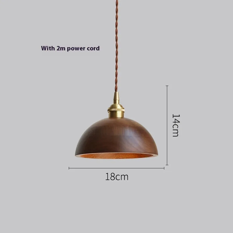 Black walnut and copper single-head droplight chandelier suspended from a ceiling.