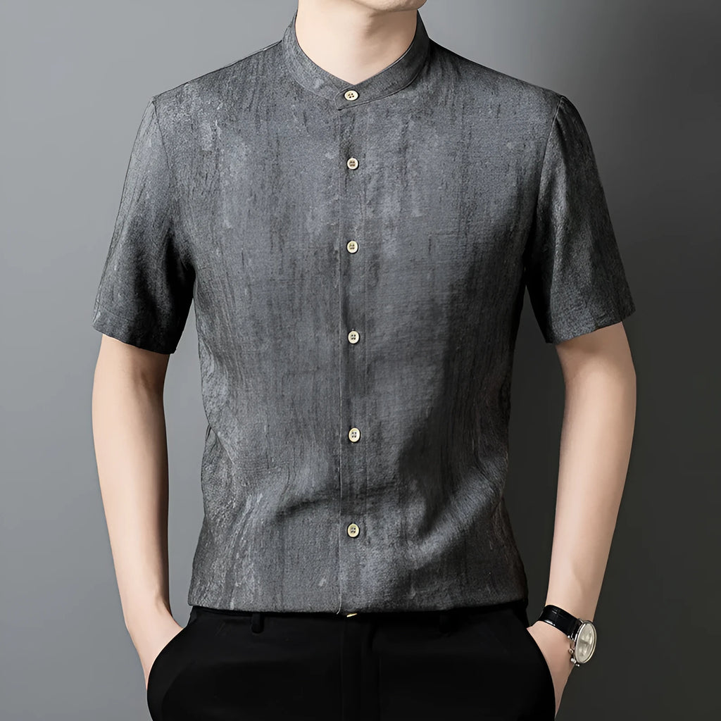 Man wearing a grey loose-fit linen blend cardigan shirt with a stand collar.