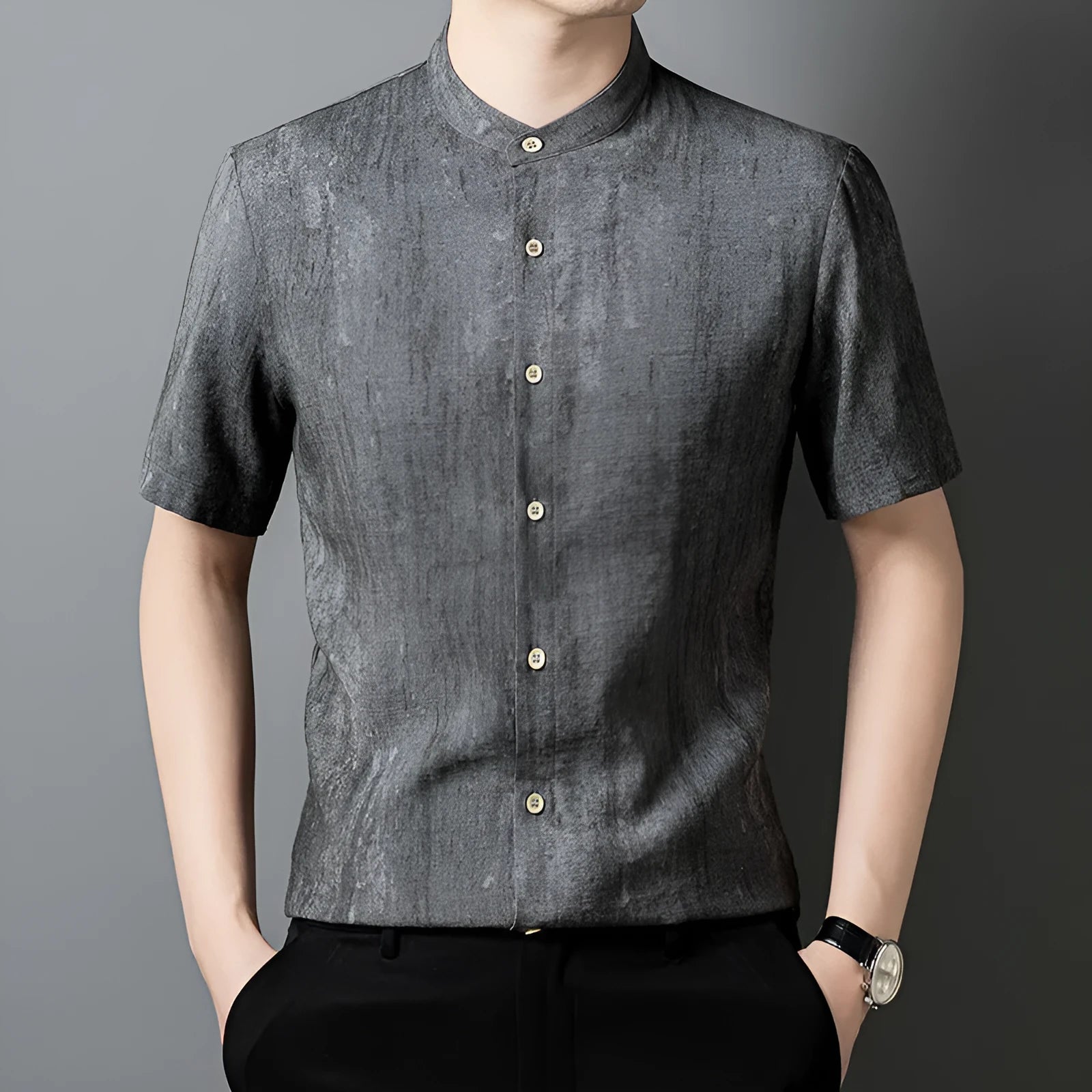 Man wearing a grey loose-fit linen blend cardigan shirt with a stand collar.