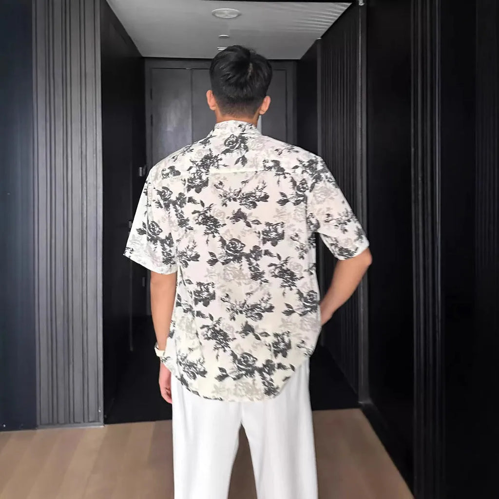 Loose fit short sleeve floral print shirt in white, shown on a hanger.