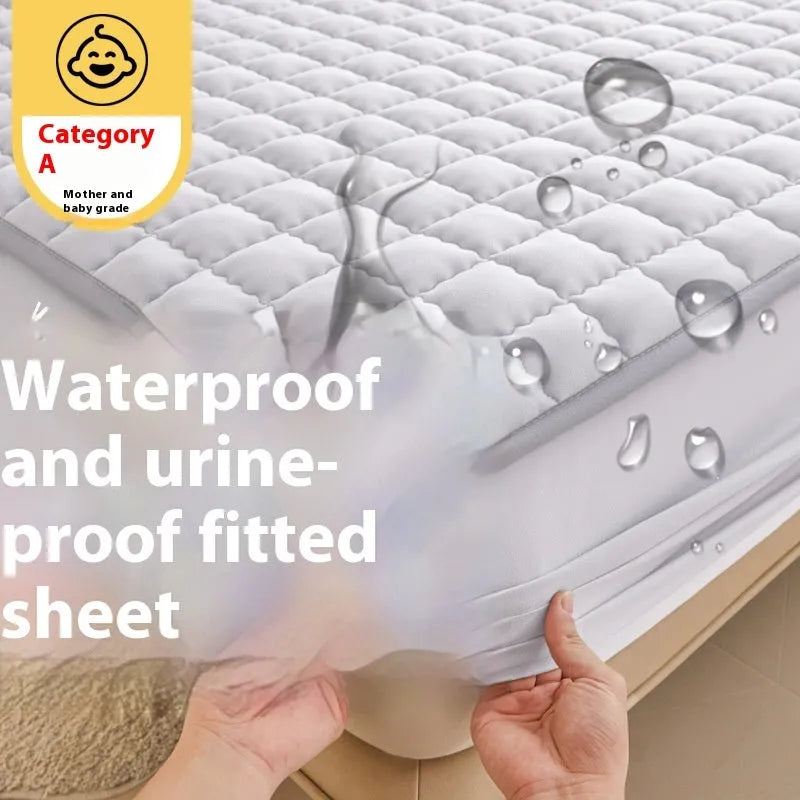 Class A waterproof fitted sheet in washed cotton, shown in a neutral colour on a bed.