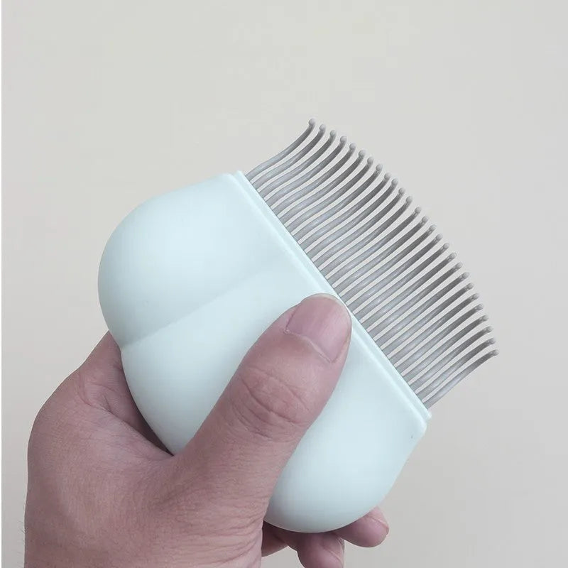Paw Soft deshedding grooming brush for cats and dogs on a white surface.