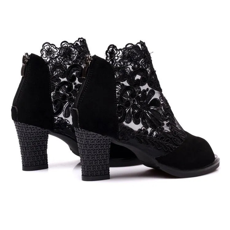 Women's black lace gladiator sandals with a square high heel and peep toe, showing zip closure