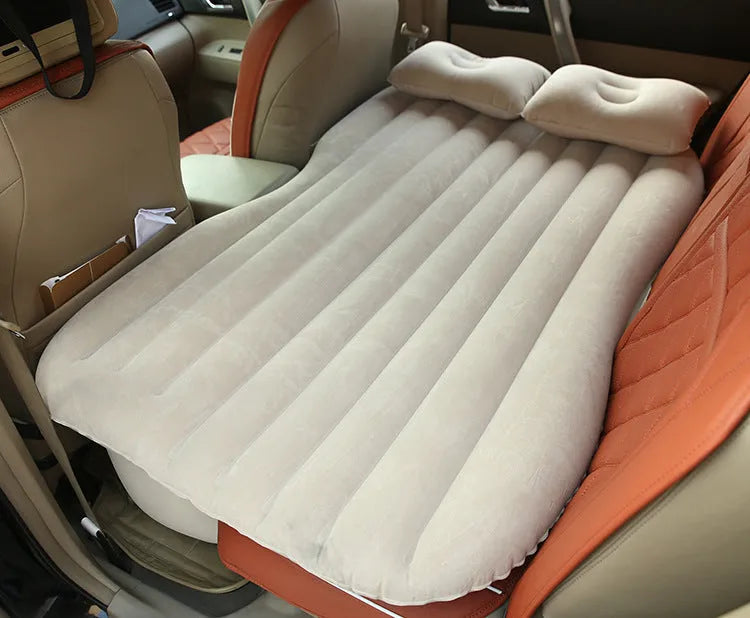 Black thickened flocking inflatable car bed set up in a vehicle with pillows.