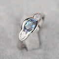 Geometric ellipse copper ring with inlaid zircon stone in a white gold tone colour.