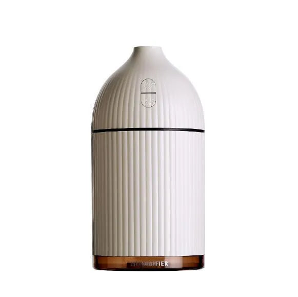 White USB-powered ultrasonic aromatherapy diffuser and humidifier with LED light on a wooden surface.
