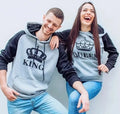 Matching printed hooded couple sweatshirts in grey with King and Queen prints on a white background