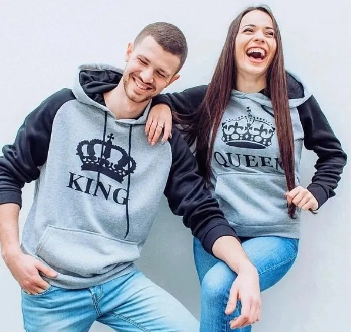 Matching printed hooded couple sweatshirts in grey with King and Queen prints on a white background