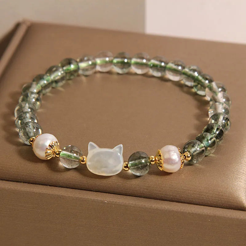 Green Phantom Quartz crystal bracelet with a detailed Shell Kitten charm on a women's wrist.