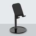 Silver white aluminium alloy desktop stand holding a mobile phone.