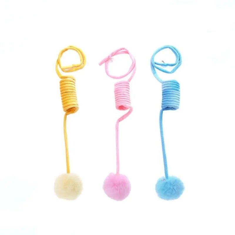 Cat toy with suction cup, spring, rabbit fur ball, and retractable elastic rope on a door