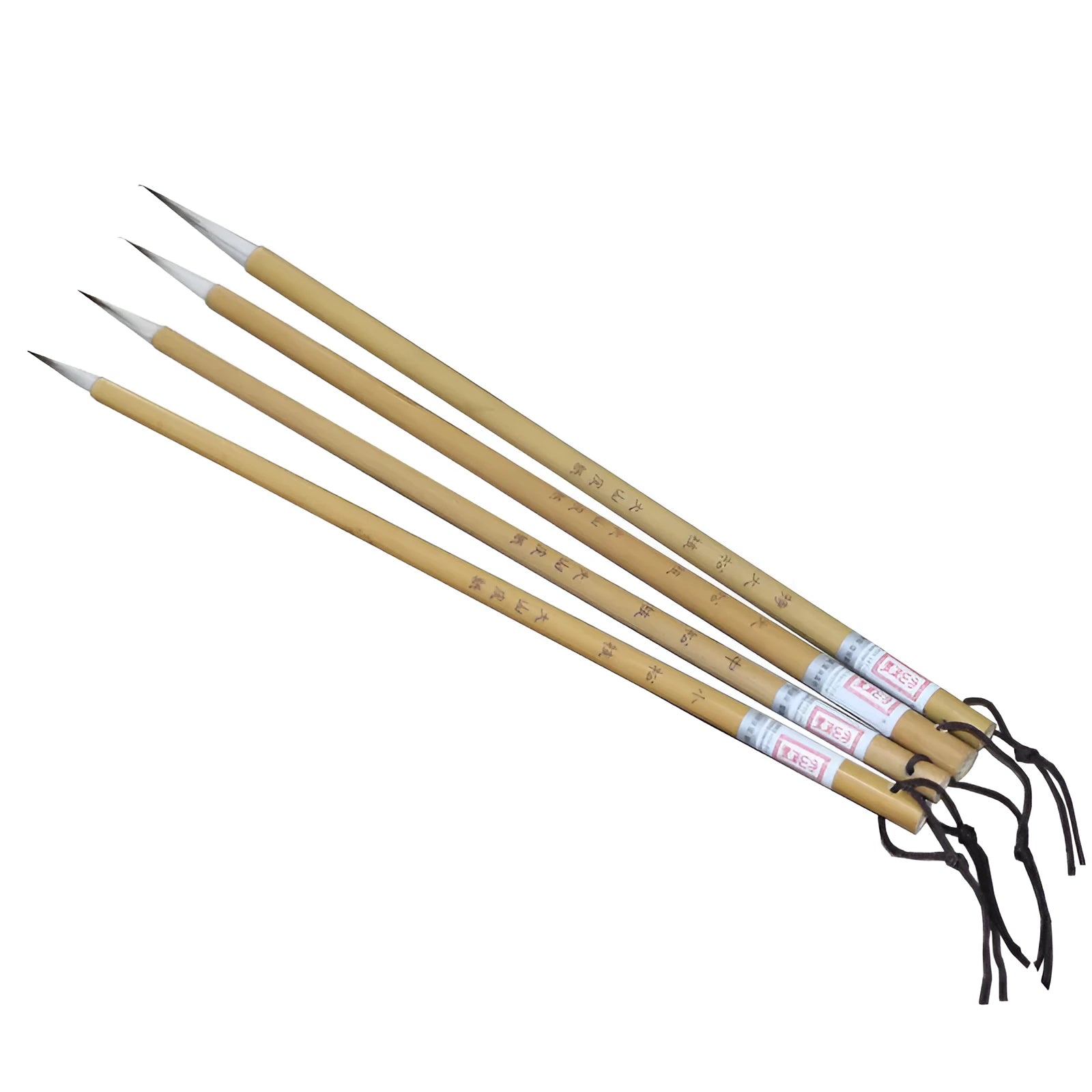 Four gold-coloured thin writing brushes with pine branch design, size 0, on a flat surface.
