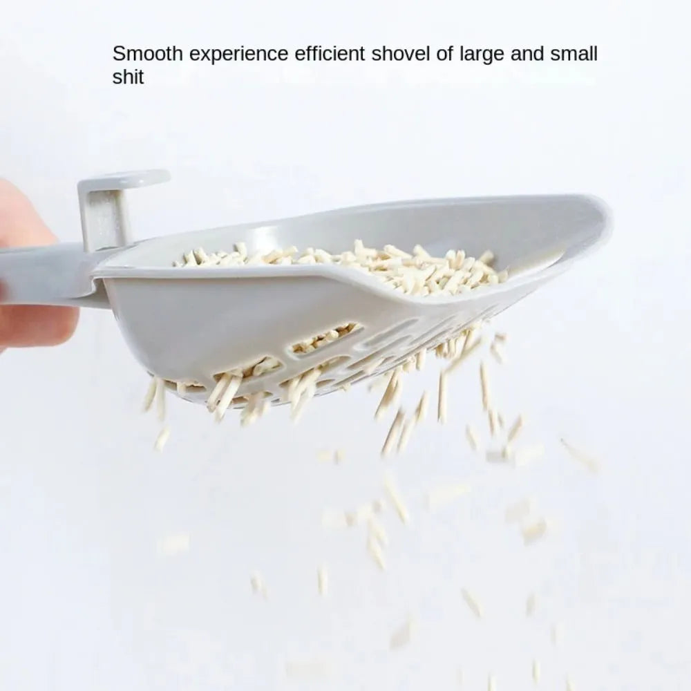 Grey plastic cat litter scoop with storage base showing self-cleaning slots and ergonomic handle