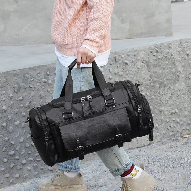 Large black travel holdall with a separate zippered shoe compartment at one end.