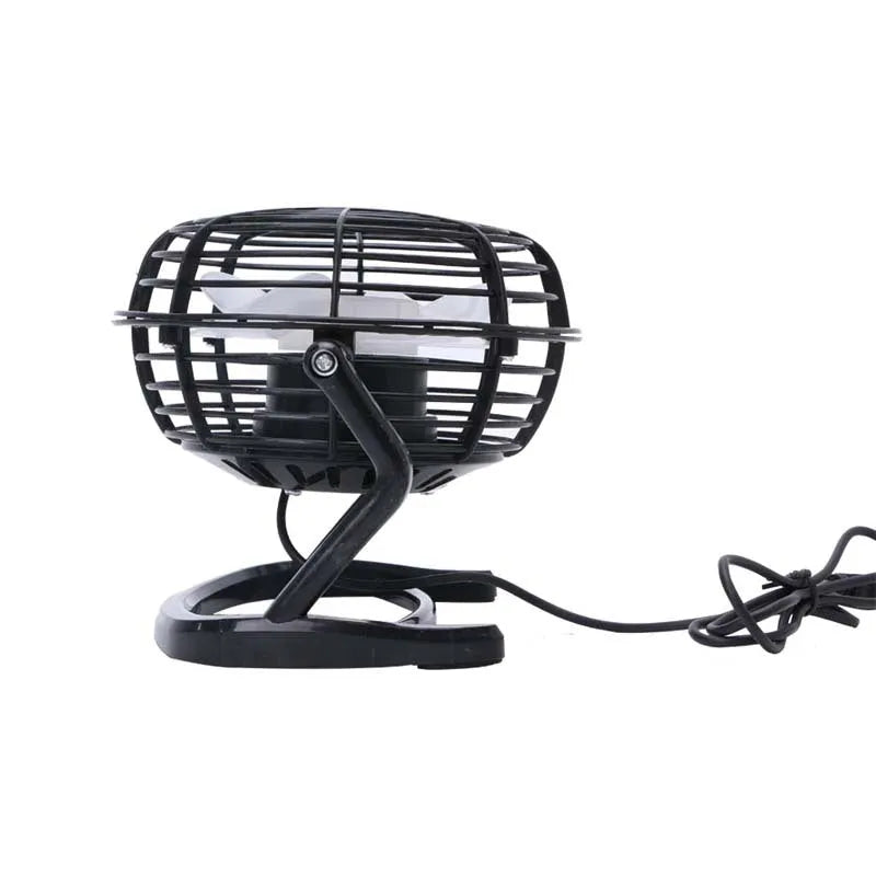 Mini adjustable tilt USB desk fan in black, shown on a desk next to a laptop
