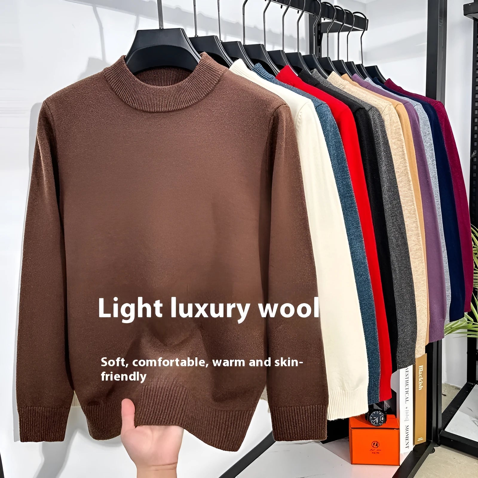 Men's solid colour fine yarn half turtleneck long sleeve pullover sweater on a hanger.