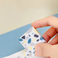 A white brick-shaped soft rubber eraser for traceless pencil correction.