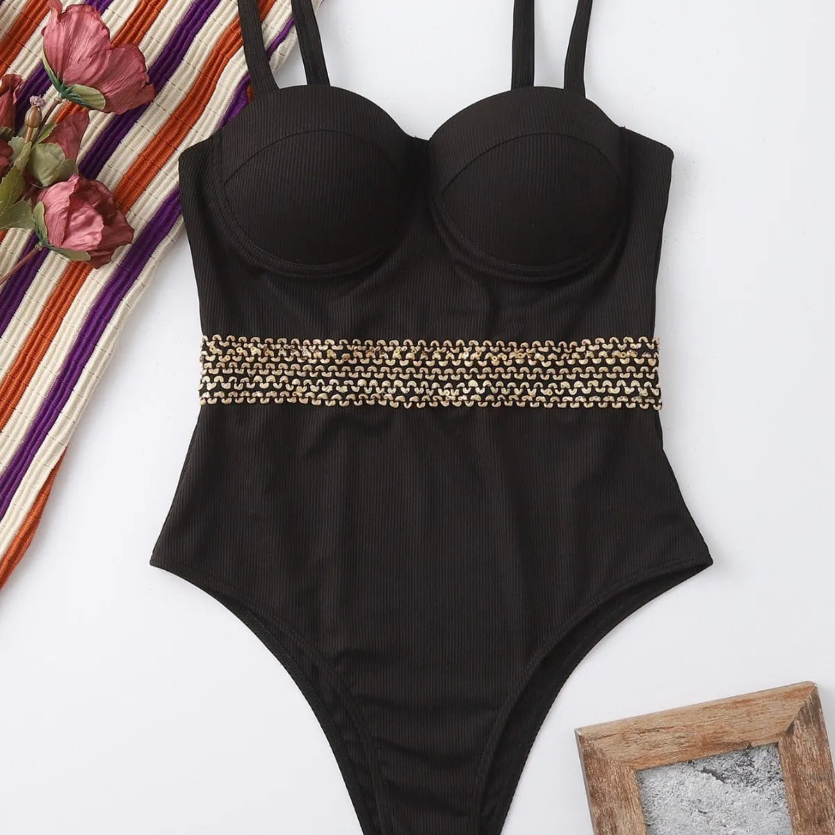 Black women's one-piece swimsuit with adjustable shoulder straps on size chart