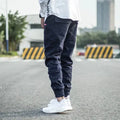 Men's casual tight-fitting pencil trousers in Khaki, front view, zipper placket visible