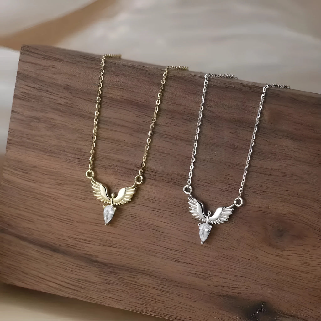 Close-up of a women's adjustable silver necklace with an eagle pendant on an O-ring chain, showing white gold and yellow gold colour options.