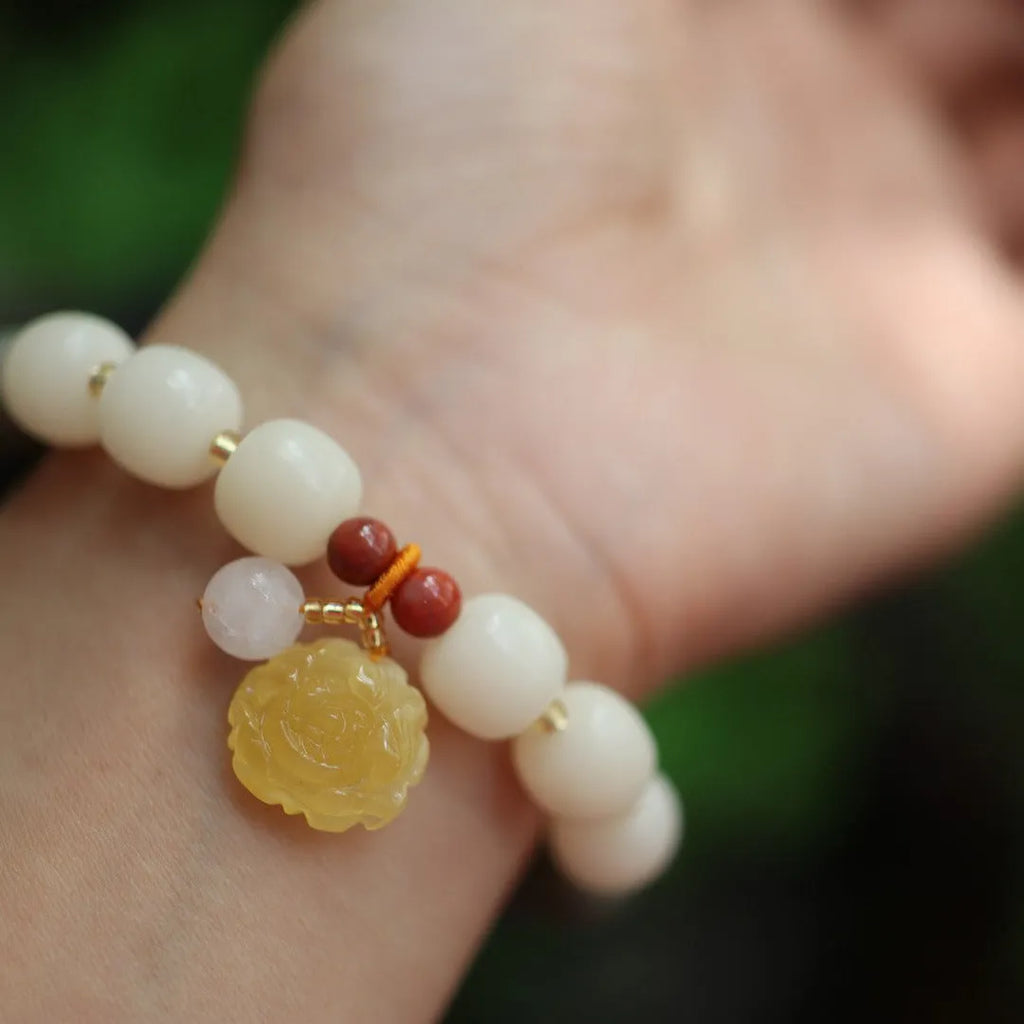 Bodhi root bracelet with gradient white jade and beeswax lotus pendants