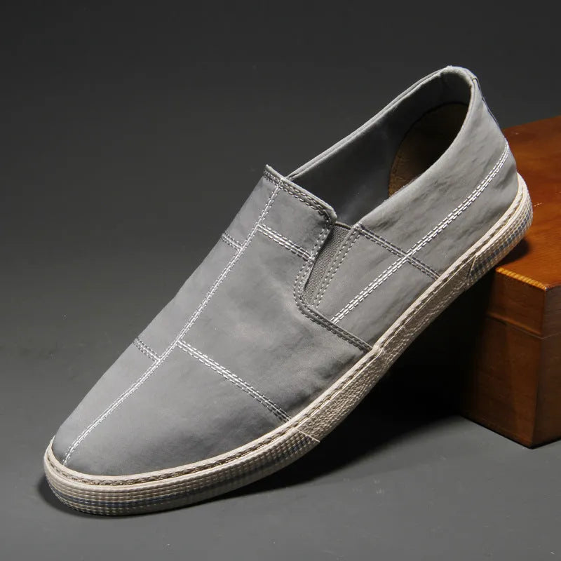 Men's slip-on canvas shoes in various colours showing round toe and low-top design