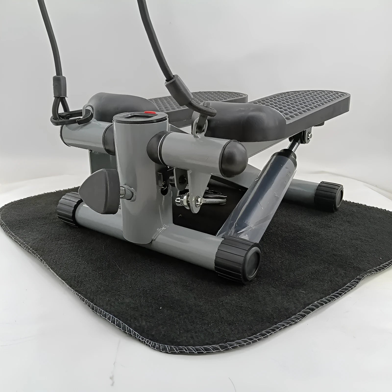 Silver grey household hydraulic pedal exercise machine for waist slimming and cardio.