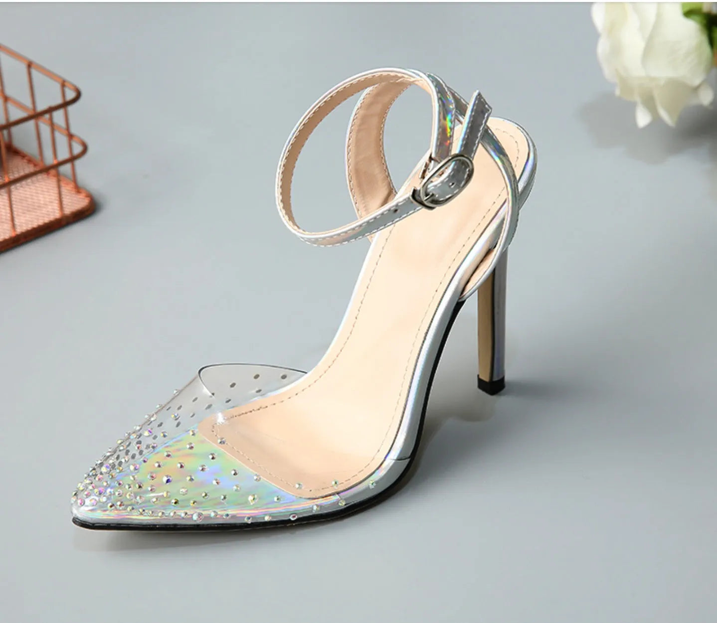 Women's pointed-toe PVC sandals with a stiletto heel on a plain background.