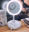 White acrylic LED vanity mirror with foldable design and USB charging port