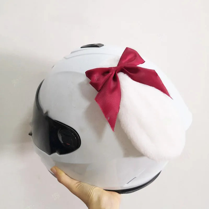 Black carbon fibre rabbit ears decoration attached to a motorcycle helmet