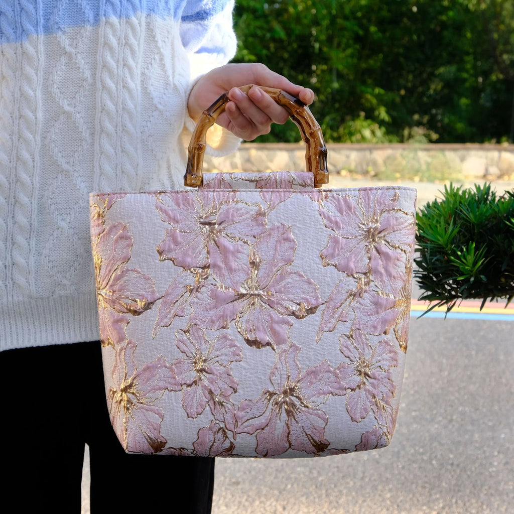 Light blue canvas shoulder bag with bronzing flower pattern, showing square shape and double shoulder straps