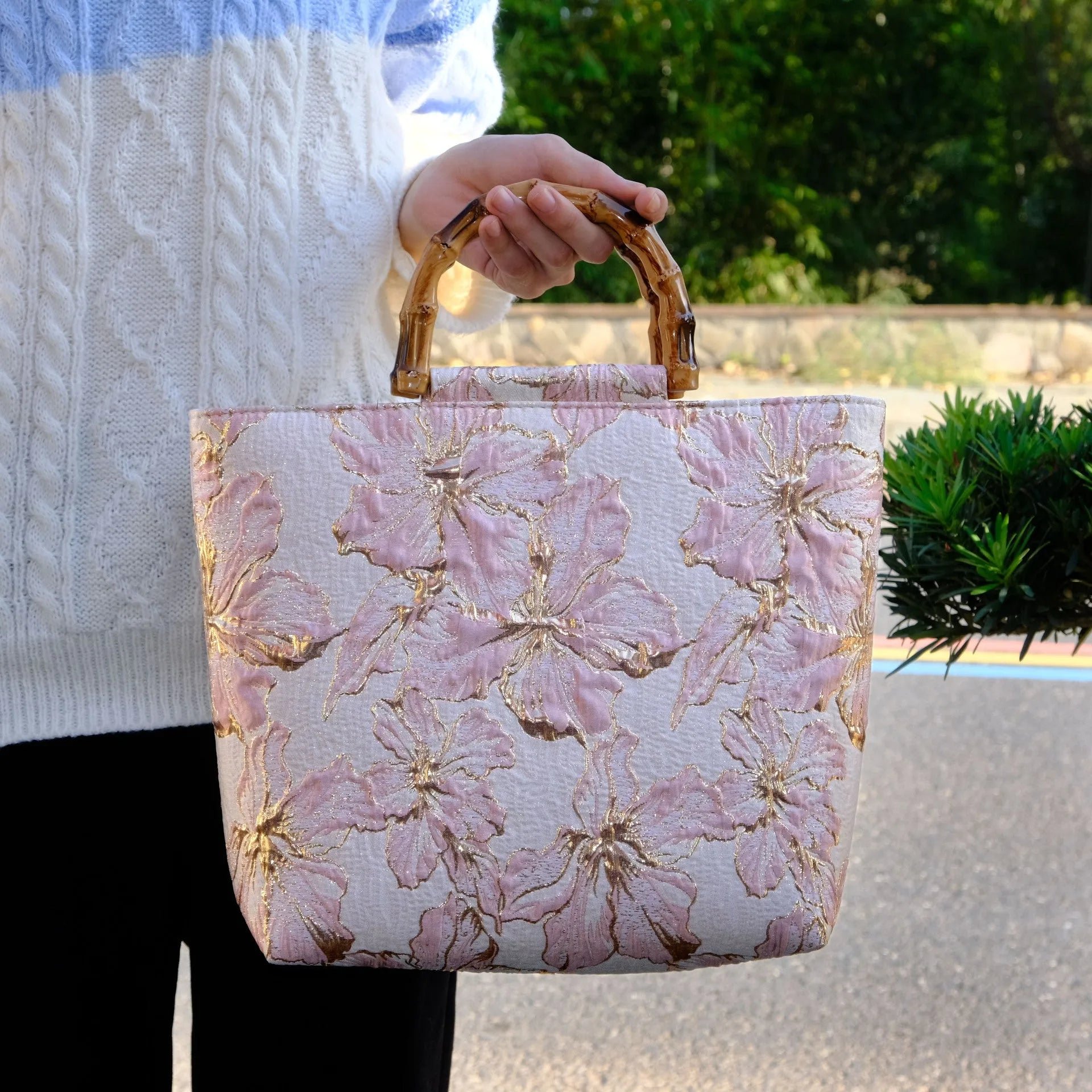 Light blue canvas shoulder bag with bronzing flower pattern, showing square shape and double shoulder straps