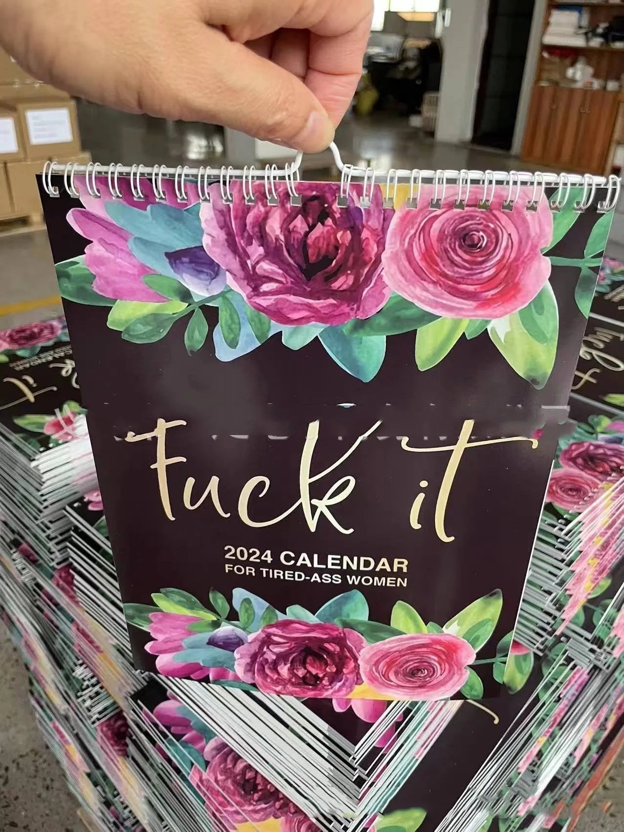 2024 wall calendar for tired women with coil binding showing monthly spread and funny sweary sayings