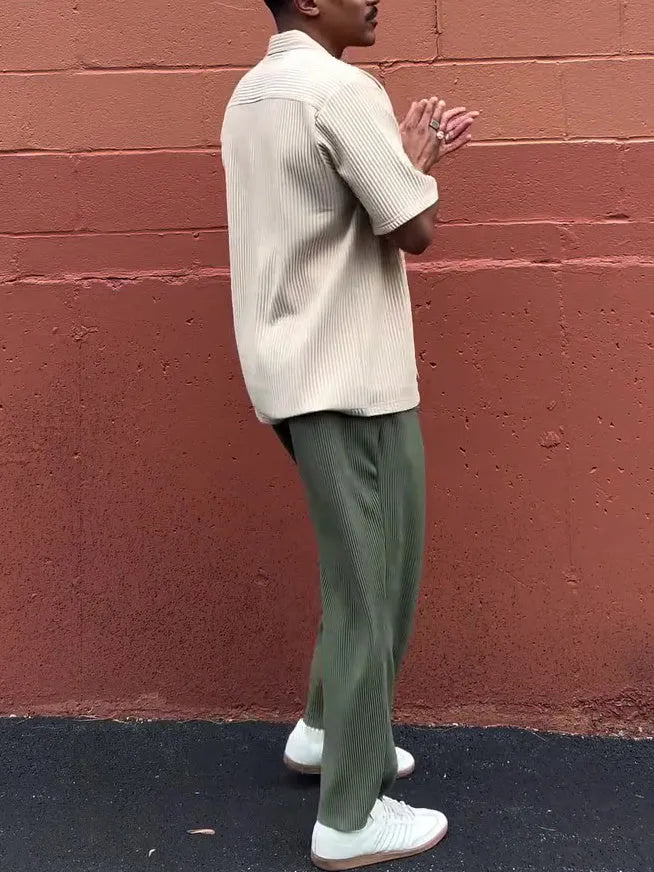 Green men's pleated casual trousers showing ankle-length cut and regular fit