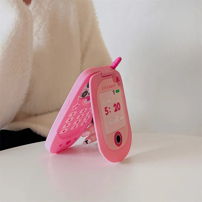 Light pink silicone flip phone case with built-in mirror for iPhone on a table