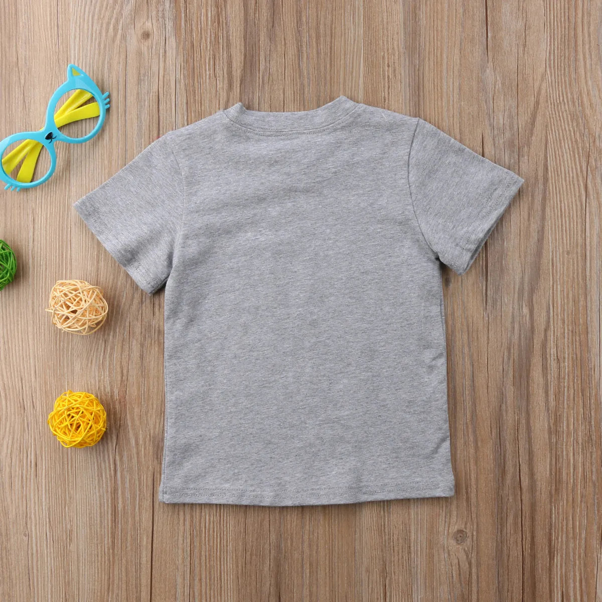 Grey printed cotton t-shirt shown in sizes for children and adults.
