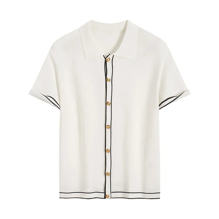 White short-sleeve cardigan with dark contrast lapels, shown on a model, old money style.