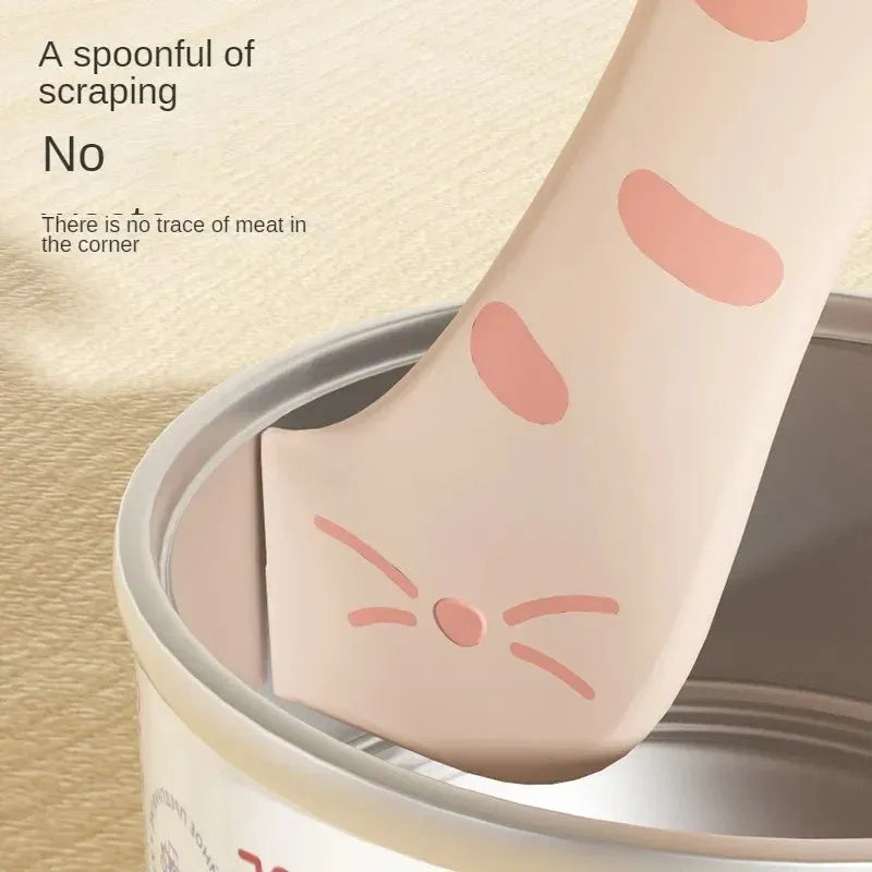 Grey silicone pet food spoon with integrated can opener and matching sealing lid for tins.