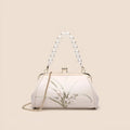 Beige shell-shaped women's shoulder bag with embroidery detail on soft PU leather.