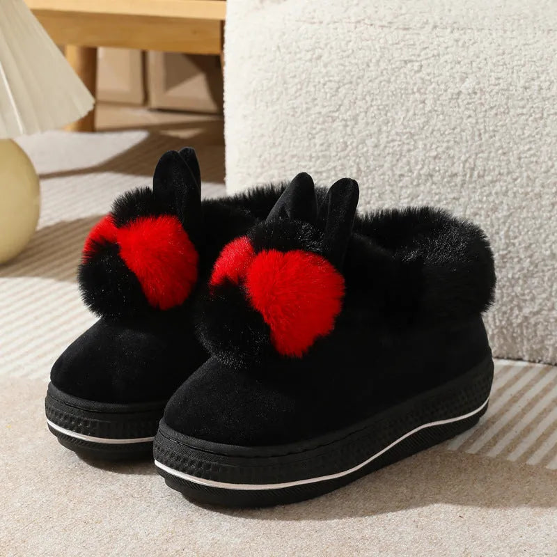 A pair of high-heel winter slippers with a plush fabric upper and a thick TPR sole.
