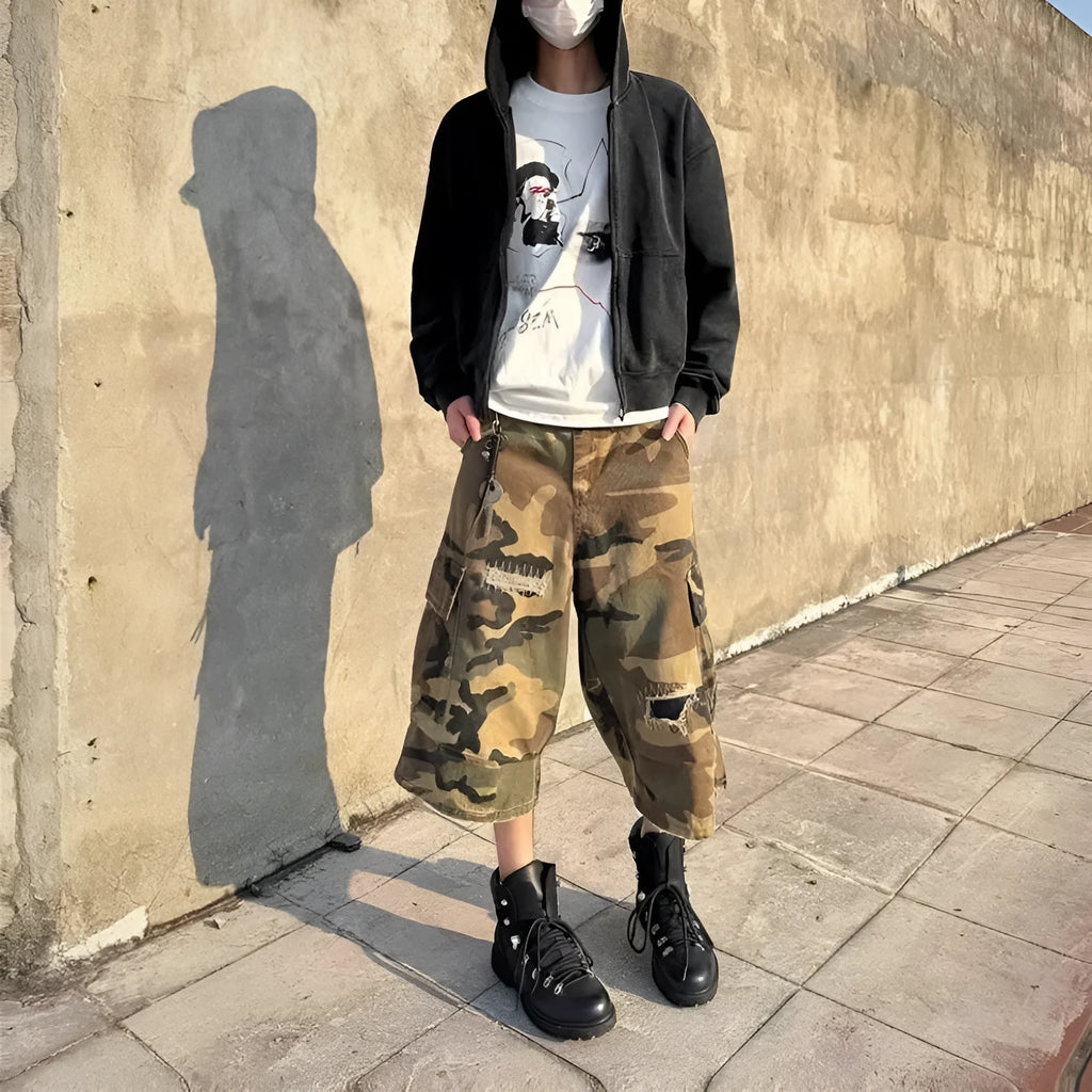 Men's loose straight-leg jeans in camouflage colour with cropped length and distressed patch detailing