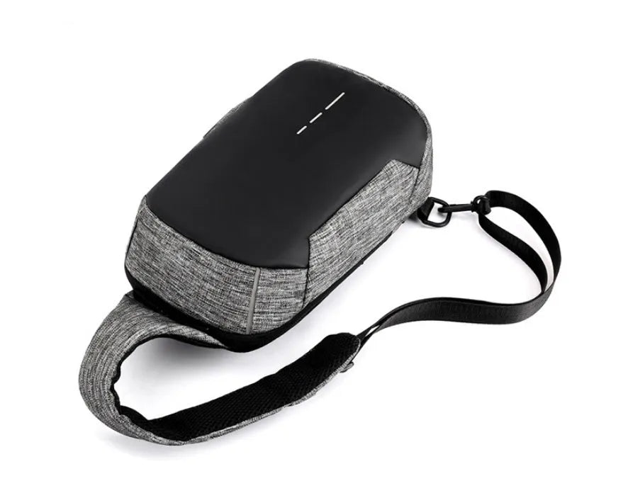 Dark blue Oxford cloth chest bag with adjustable strap, shown open to reveal internal mobile phone pocket.