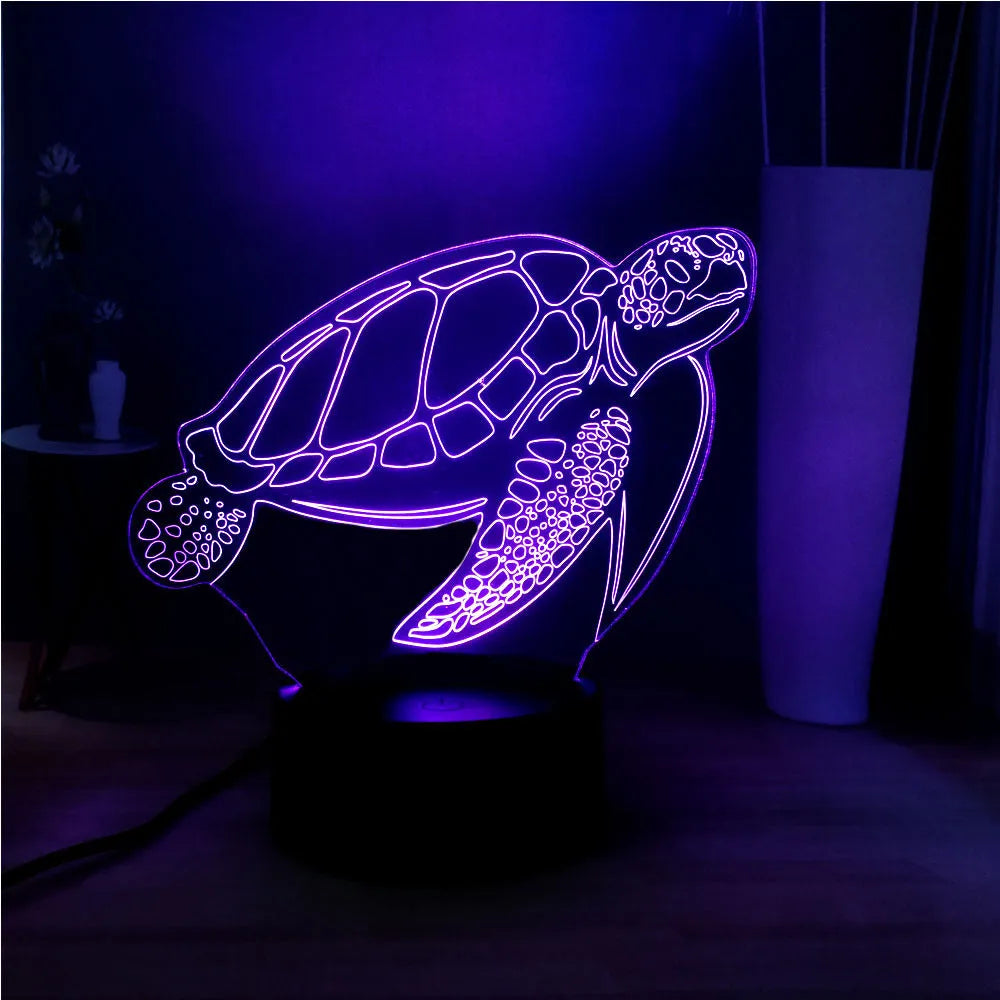 3D sculpted green turtle LED night light glowing with multi-colours on a dark surface