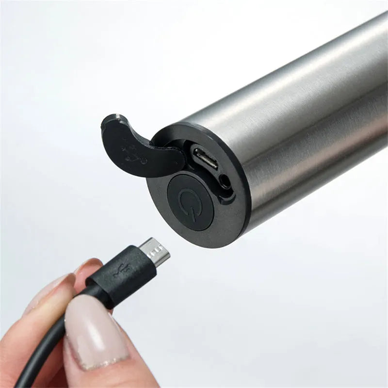 Silver electric milk frother handheld whisk with double stainless steel head on white background
