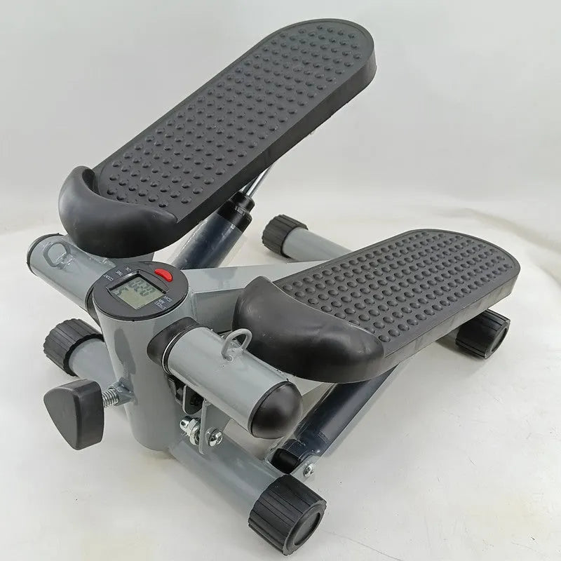 Silver grey household hydraulic pedal exercise machine for waist slimming and cardio.