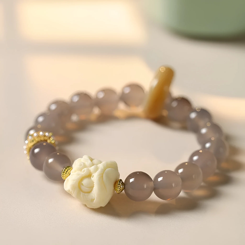 Hand-woven gray agate and mellite bracelet with 10mm round beads